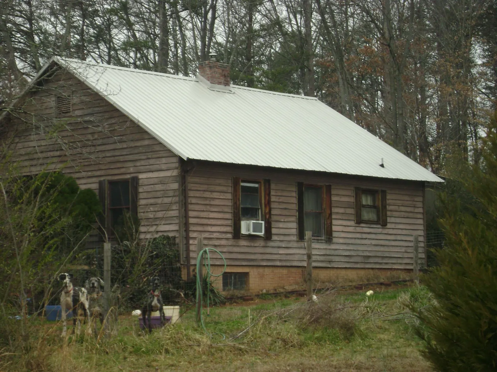 White metal roof on an old wood sided farmhouse, from a Metal Roof Installation job in Onondaga